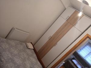 a bedroom with a bed and a sliding glass door at Danica apartman Foča 2 in Foča +3 photos