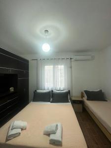 a bedroom with two beds with towels on them at Villa Murataj in Ksamil