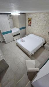 a bedroom with a large bed and a mirror at Calasetta, casa vista mare in Calasetta