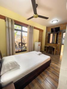 a bedroom with a bed with a ceiling fan at Hotel Casa Madrid in Puerto Berrío