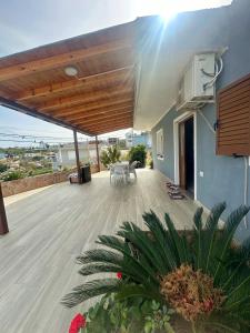 a large deck with a table and chairs on a house at Villa Murataj in Ksamil