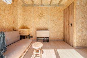 a living room with a couch and a table at Tinyhouse et abeilles, séjour insolite en Provence in Orange