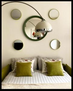 a bedroom with a mirror and a bed with pillows at La Casetta sui tetti in Bergamo