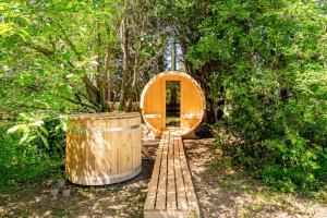 a tree house with a wooden door in a forest at Tinyhouse et abeilles, séjour insolite en Provence in Orange +9 photos