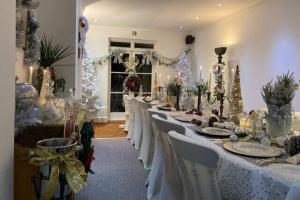 a group of tables in a room with christmas decorations at The Palace Villas - Location, Luxury and Space in Eastbourne