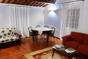 a living room with a table and chairs and a couch at Le piagge della sala in Bullicame