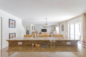 a living room with a large island in the middle of a kitchen at Clearwater Holiday Home in Clearwater