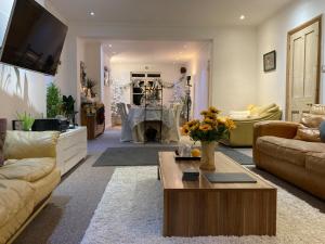 a living room with a couch and a table at The Palace Villas - Location, Luxury and Space in Eastbourne