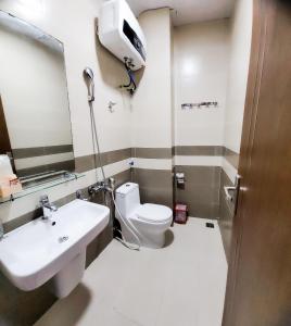 a bathroom with a toilet and a sink at Cat Ba Charm Island Hotel in Cat Ba +50 photos