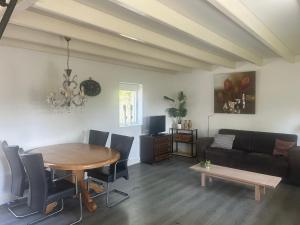a living room with a table and a couch at Zonneoord in Ede