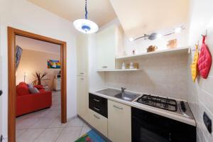 a kitchen with a sink and a stove top oven at Villa Comi in Giurdignano