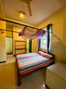 a bedroom with a bed with a mosquito net at Beach Hut in Arugam Bay +82 photos