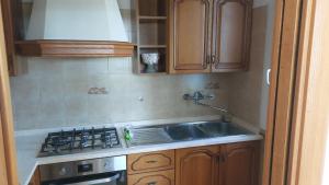 a kitchen with a sink and a stove at Appartamento Ares in Misano Adriatico +3 photos
