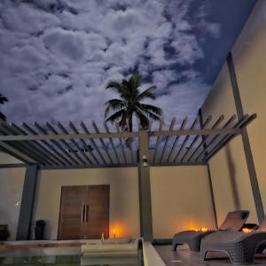 a mural of a palm tree on the side of a house at Villa Kalachuchi Bohol in Panglao