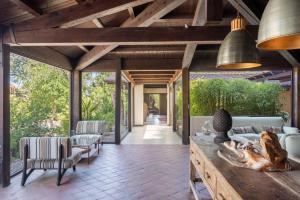 an open living room with vaulted ceilings and a wooden ceiling at Vallegrande Nature Resort by Geocharme in Cefalù