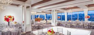 a ballroom with tables and chairs in a room with large windows at Cameo Beverly Hills in Los Angeles +67 photos