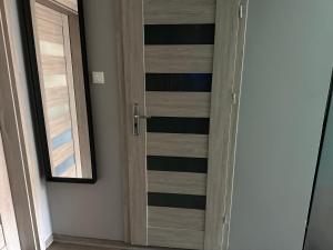 a wooden door in a room with a window at Loft&Cozy in Zgorzelec