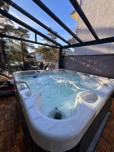 a jacuzzi tub with a toilet in it at Villa Azalia in Jastrzębia Góra