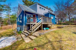 a blue house with a porch and stairs to it at Breezy Marie in Nameloc Heights