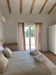 a bedroom with a large bed with two towels on it at Villa Botanica in Bale