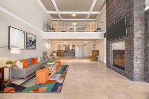 a living room with a couch and a fireplace at Best Western Plus Grand Manor Inn in Springfield