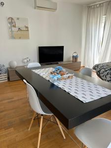 a black table with chairs and a bed in a room at Casalura in Polignano a Mare