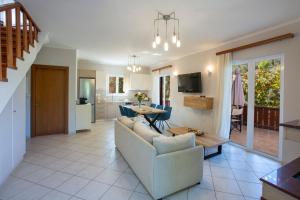 a living room with a couch and a table at Evridiki's Villas in Agios Nikitas