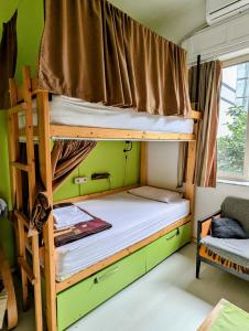 two bunk beds in a room with a green wall at Tirana Backpacker Hostel in Tirana +36 photos