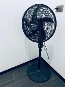 a black fan sitting on the floor next to a wall at Encanto junto al lago en la zona viva in San Pedro La Laguna +46 photos