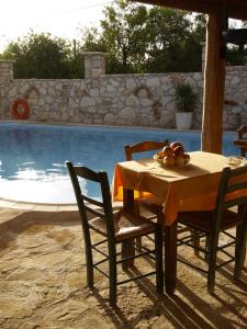 un tavolo e sedie accanto alla piscina di Natalia's Houses a Chania Altre 17 foto