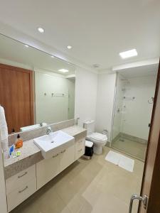 a bathroom with a sink and a toilet and a mirror at Apart Vista Azul - hospedagem nas montanhas in Domingos Martins