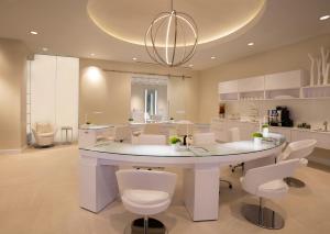 a large kitchen with a table and white chairs at The Breakers Palm Beach in Palm Beach