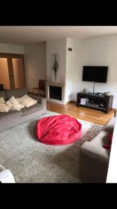 a living room with a red blanket on the floor at Luxury apartment in Espinho +16 photos