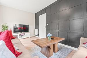a living room with a couch and a table at 247 Serviced Accommodation in Telford 4BR House in Telford