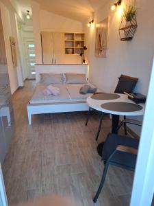 a small room with a bed and two tables at Apartmani Goga - Molat 6 in Molat