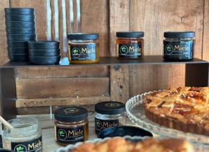 a table topped with jars of jam and a pie at Vallegrande Nature Resort by Geocharme in Cefalù