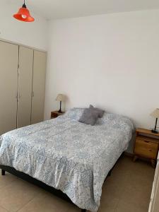 a bedroom with a bed and two night stands at Almirante Brown 235 PLATA ALTA D-3 in San Martín