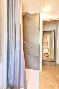 a shower with a glass door in a bathroom at Apartment Monti e Lago - Tignale in Tignale +10 photos