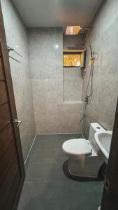 a bathroom with a toilet and a sink at Tiwi's Travellers Inn - Solar Powered, Starlink, Scooter Rental, Palawan Tours in Puerto Princesa City +35 photos