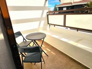 a balcony with two chairs and a table on a building at Casa Conchita - Los Cancajos in Los Cancajos +30 photos