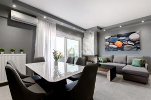a dining room with a glass table and chairs at September15 Suites, Amfilochia in Amfilochia