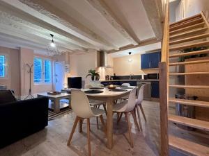 a kitchen and dining room with a table and chairs at Brive Republique in Brive-la-Gaillarde