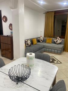 a living room with a table and a couch at Appartement City Agadir 2 in Agadir