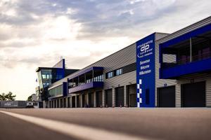 a large building with a blue and white building at Studio Prenois in Prenois