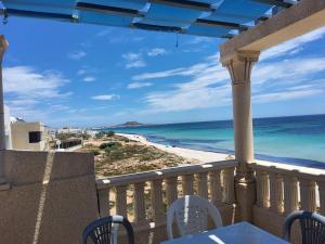 a balcony with a view of the beach and ocean at Casa amine in Kelibia