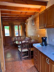 a kitchen and dining room with a table and chairs at Duplex Ñancu Lahuen 1 Y 2 in Villa Traful