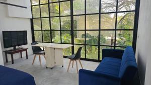 a living room with a blue couch and a table at casaroja in Palenque