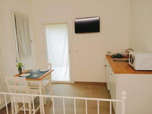 a small kitchen with a table and a counter top at Modena Rooms in Modena