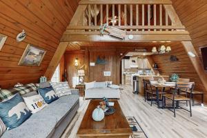 a living room with a couch and a table at Alpine Retreat in Gatlinburg