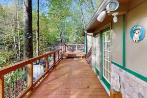 a walkway to the porch of a cabin in the woods at Alpine Retreat in Gatlinburg